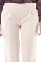 Stunning off-white pants with reverse double pleats and vertical pockets. Snug fit with a zipper fly and a buttoned waistband for front closure, these handmade pants put to view beautifully hand sewn hems and cuffs. They can be styled with custom shirts and vests.