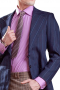 A handmade single breasted two button blazer with made to order straight-edged notch lapels, a tailor made boutonniere on the left lapel, custom made rounded lower patch pockets, and a center vent made for fashion-forward men.