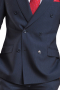 This men's pant suit is tailor made in a fine wool blend, featuring a double breasted button closure, peak lapels, and handsewn cuffs. 