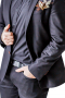 This men's pant suit is tailor made in a fine wool blend and cut to a slim fit, featuring a single breasted button closure and horizontal pockets. 