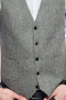 A stunning made to measure men's light grey slim cut vest is tailor made in a wool blend, featuring a single breasted closure and adjustable back buckle.