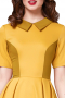 This women's retro inspired dress is tailor made in a fine wool blend. It features a concealed zipper and a preppy collar, with color block detailing cinching in the waist. 