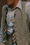 In a custom grey beige is this men's hand-tailored vest with a flattering classic neckline and fit. This bespoke-made vest has a stunning faint plaid pattern that is sophistically muted for debonair class.