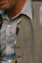 In a custom grey beige is this men's hand-tailored vest with a flattering classic neckline and fit. This bespoke-made vest has a stunning faint plaid pattern that is sophistically muted for debonair class.