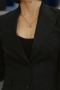 Woman’s custom tailored mono-chromatic suit from Hollywood. This is a custom tailored black suit made as a custom Hollywood costume for sale online.