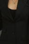 Woman’s custom tailored mono-chromatic suit from Hollywood. This is a custom tailored black suit made as a custom Hollywood costume for sale online.