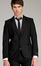 A slim cut single breasted one button smart casual tuxedo jacket custom tailored with an elegant shawl collar and extra soft shoulder padding.