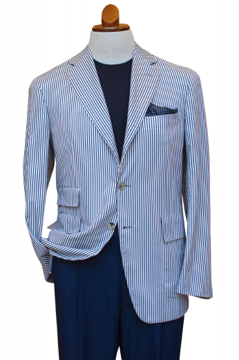 This mens tailor made wool and linen mix blazer in white flaunts a stunning display of black vertical stripes all over. It is a single breasted formal festooned with a stylish centre vent, 2 front closure buttons, 2 3-inch-wide notch lapels, 1 upper welt pocket, 2 lower flapped pockets, and 1 elegant flapped ticket pocket on the right. Order online at My Custom Tailor where skilful fabric magicians can also hand stitch the edges of the pockets and lapels.