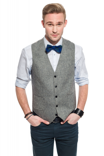 A stunning made to measure men's light grey slim cut vest is tailor made in a wool blend, featuring a single breasted closure and adjustable back buckle. 